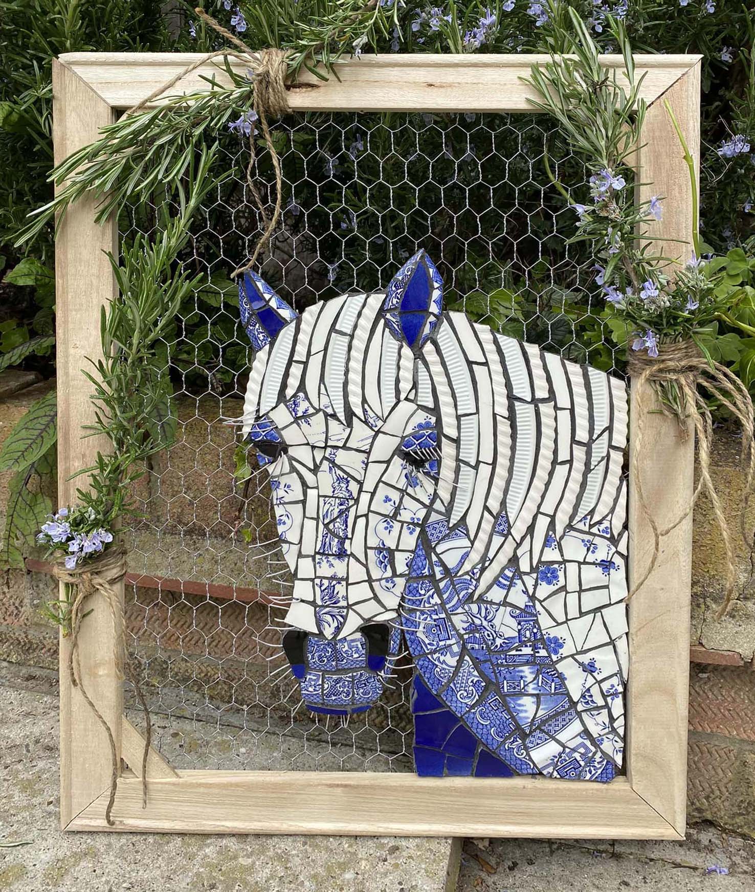Vintage crockery horses on mosaic mesh on chicken wire. Homemade frame.