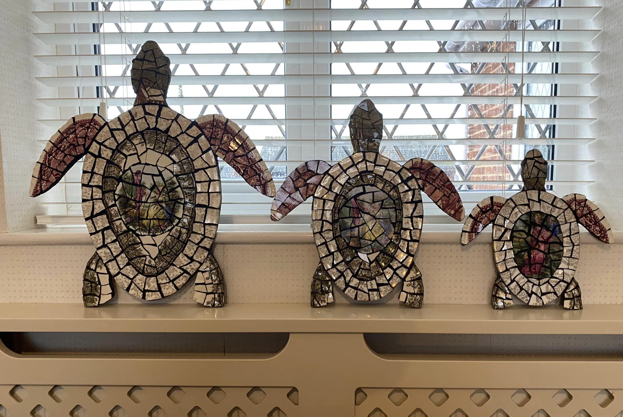 Family of Turtles. Mosaic is vintage crockery on cement board for indoors or outdoors. Black grouting.