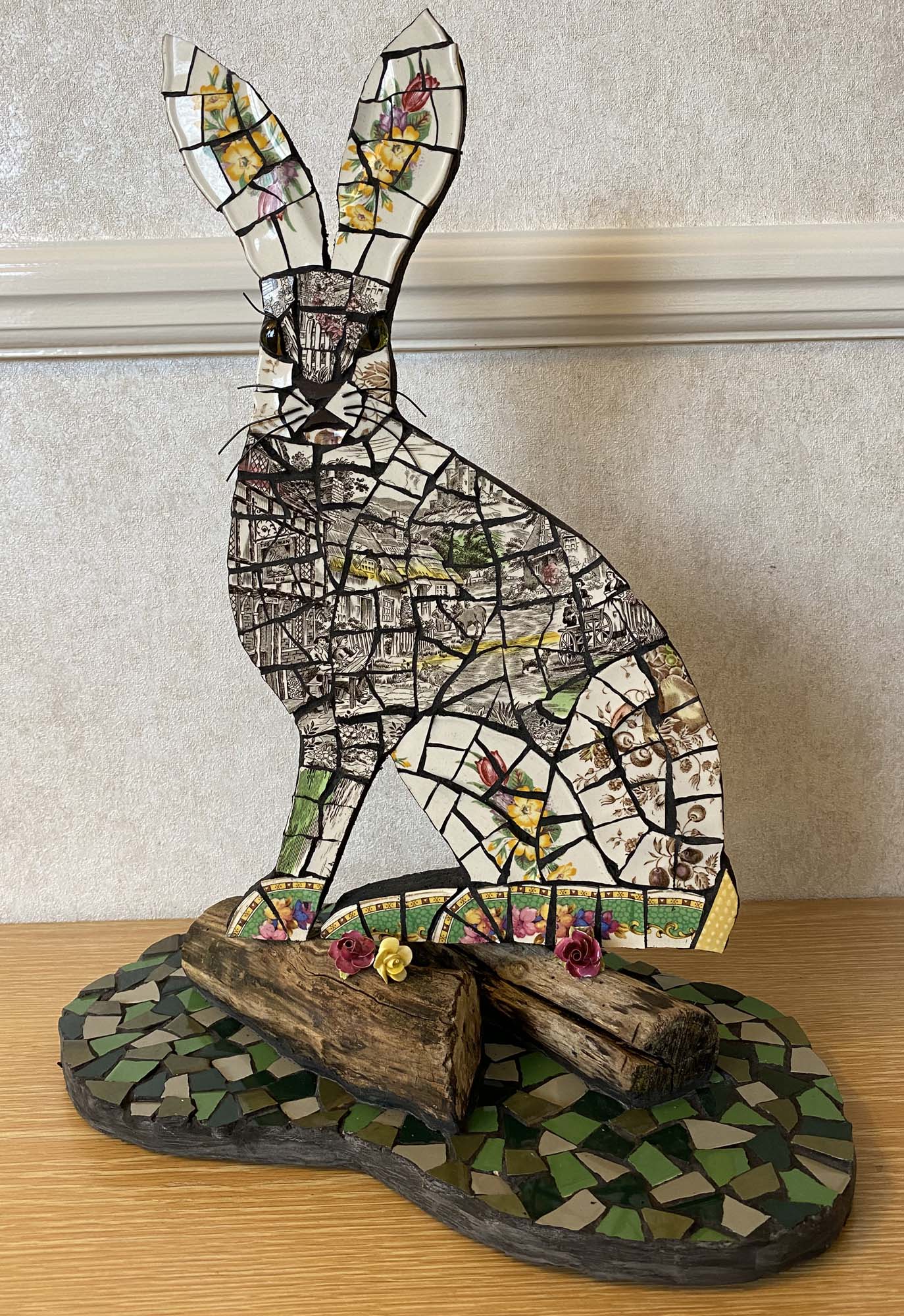 Vintage china hare mosaic on cement board for indoors or outdoors. Black grouting.