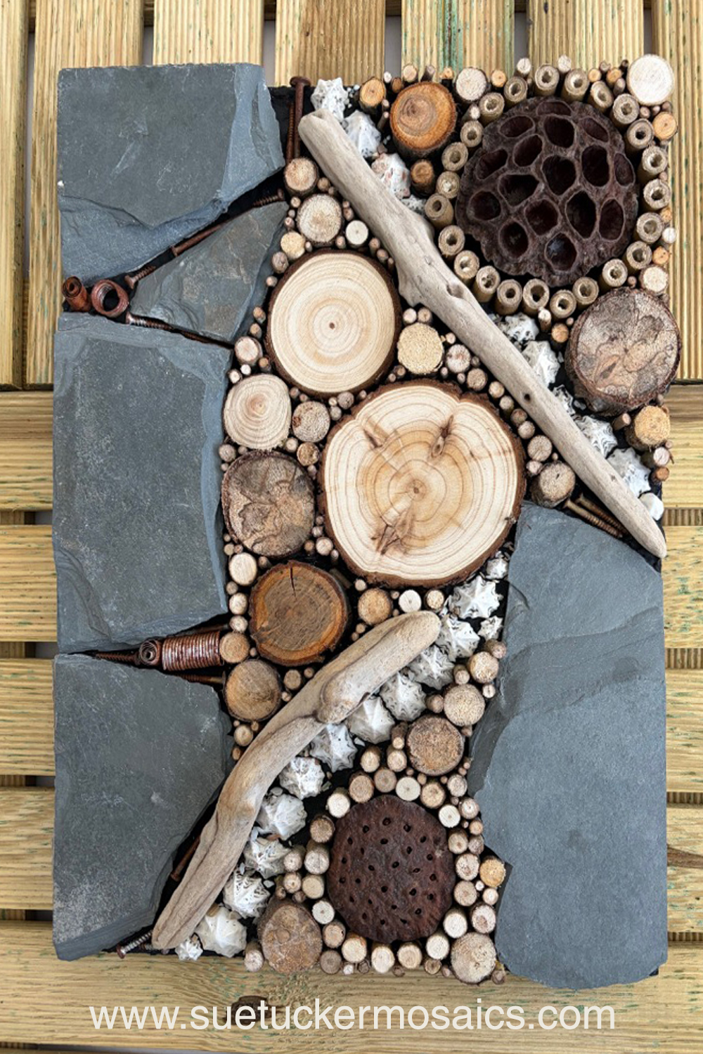 Aerial views of the earth have influenced my collection of mixed-media wall art. These pieces capture the essence of forests, woodlands, farmland, mountains, volcanoes, rock formations, oceans, meandering rivers and streams. Using logs, branches, twigs, driftwood, bamboo, bark, slate, seed pods, shells, moss, stones, and ceramic fragments—along with nails and springs naturally weathered over time.