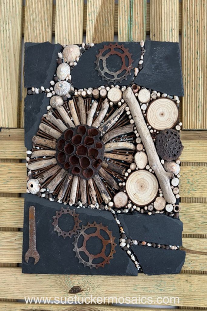 Aerial views of the earth have influenced my collection of mixed-media wall art. These pieces capture the essence of forests, woodlands, farmland, mountains, volcanoes, rock formations, oceans, meandering rivers and streams. Using logs, branches, twigs, driftwood, bamboo, bark, slate, seed pods, shells, moss, stones, and ceramic fragments—along with nails and springs naturally weathered over time.