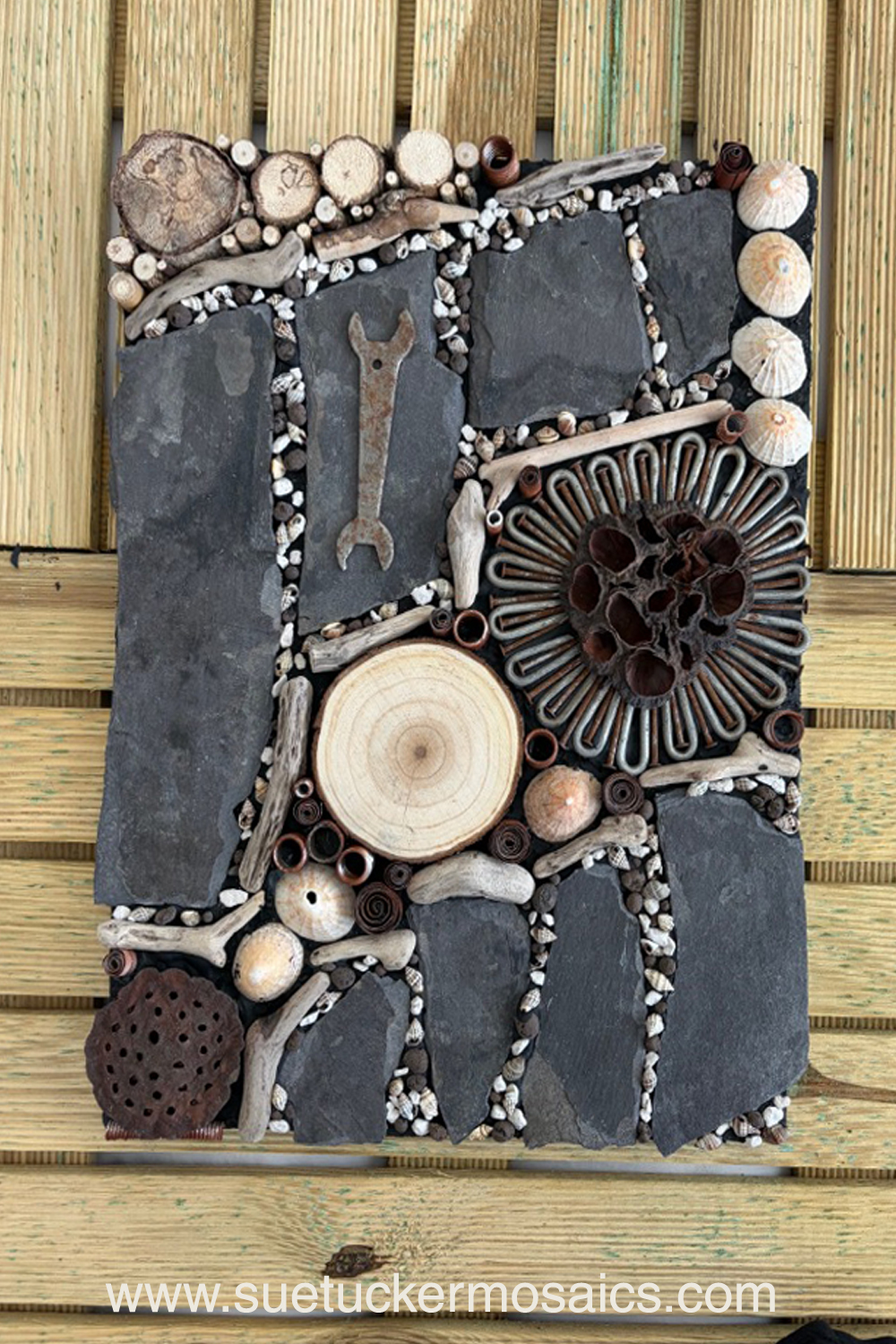 Aerial views of the earth have influenced my collection of mixed-media wall art. These pieces capture the essence of forests, woodlands, farmland, mountains, volcanoes, rock formations, oceans, meandering rivers and streams. Using logs, branches, twigs, driftwood, bamboo, bark, slate, seed pods, shells, moss, stones, and ceramic fragments—along with nails and springs naturally weathered over time.