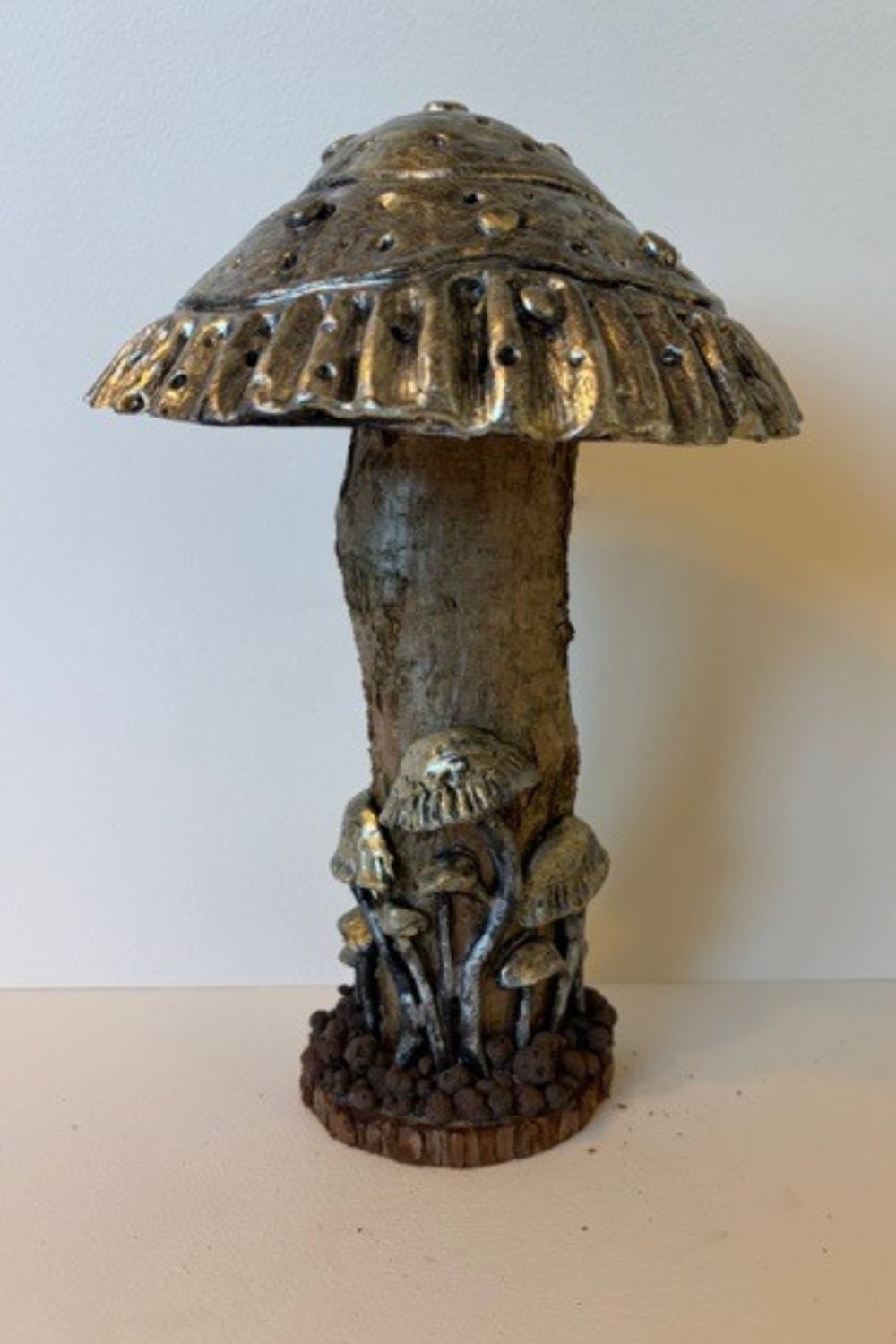 Each piece in my mushroom ornament collection is a celebration of nature and craftsmanship. Cast in eco-conscious resin and formed within bespoke silicone moulds that I create by hand, every ornament begins as a carefully considered, original design. Layers of metallic pigment are delicately applied to enhance texture and depth, before being sealed with a lustrous high-gloss varnish that catches the light beautifully. The forms are then grounded on natural log bases, each one unique, bringing an authentic connection to the woodland from which they are inspired. No two pieces are ever the same—each ornament is a small, sculptural work of art, where organic materials meet refined finish.