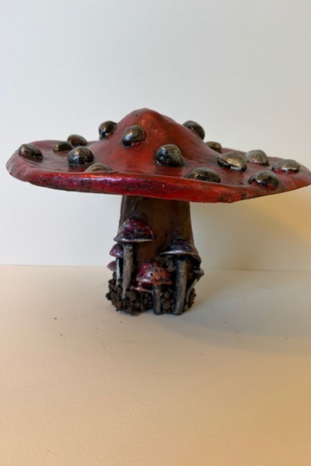 Each piece in my mushroom ornament collection is a celebration of nature and craftsmanship. Cast in eco-conscious resin and formed within bespoke silicone moulds that I create by hand, every ornament begins as a carefully considered, original design. Layers of metallic pigment are delicately applied to enhance texture and depth, before being sealed with a lustrous high-gloss varnish that catches the light beautifully. The forms are then grounded on natural log bases, each one unique, bringing an authentic connection to the woodland from which they are inspired. No two pieces are ever the same—each ornament is a small, sculptural work of art, where organic materials meet refined finish.