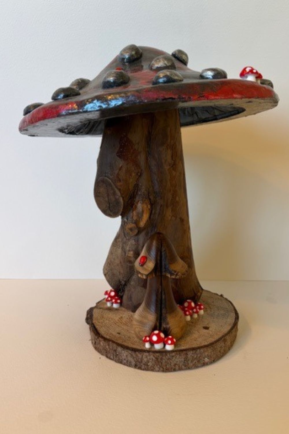 Each piece in my mushroom ornament collection is a celebration of nature and craftsmanship. Cast in eco-conscious resin and formed within bespoke silicone moulds that I create by hand, every ornament begins as a carefully considered, original design. Layers of metallic pigment are delicately applied to enhance texture and depth, before being sealed with a lustrous high-gloss varnish that catches the light beautifully. The forms are then grounded on natural log bases, each one unique, bringing an authentic connection to the woodland from which they are inspired. No two pieces are ever the same—each ornament is a small, sculptural work of art, where organic materials meet refined finish.