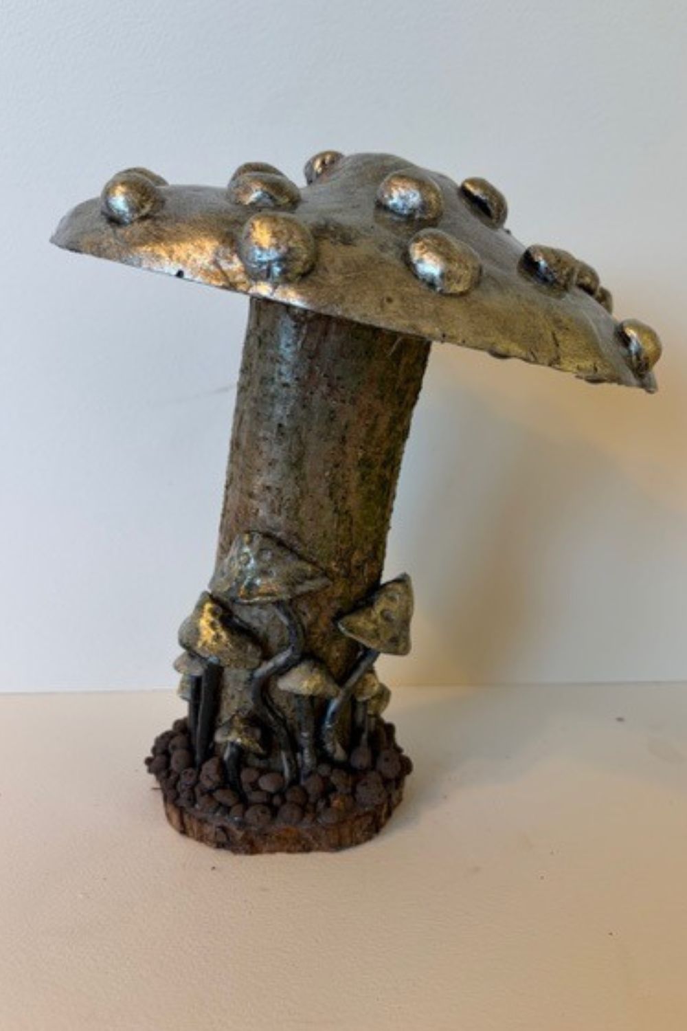 Each piece in my mushroom ornament collection is a celebration of nature and craftsmanship. Cast in eco-conscious resin and formed within bespoke silicone moulds that I create by hand, every ornament begins as a carefully considered, original design. Layers of metallic pigment are delicately applied to enhance texture and depth, before being sealed with a lustrous high-gloss varnish that catches the light beautifully. The forms are then grounded on natural log bases, each one unique, bringing an authentic connection to the woodland from which they are inspired. No two pieces are ever the same—each ornament is a small, sculptural work of art, where organic materials meet refined finish.