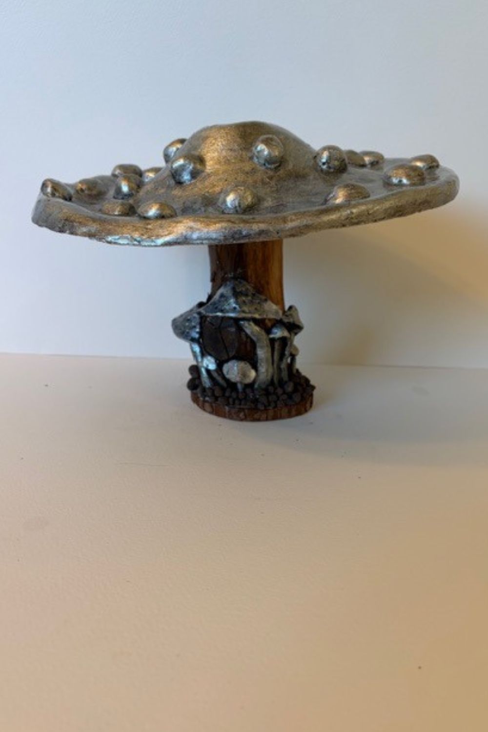 Each piece in my mushroom ornament collection is a celebration of nature and craftsmanship. Cast in eco-conscious resin and formed within bespoke silicone moulds that I create by hand, every ornament begins as a carefully considered, original design. Layers of metallic pigment are delicately applied to enhance texture and depth, before being sealed with a lustrous high-gloss varnish that catches the light beautifully. The forms are then grounded on natural log bases, each one unique, bringing an authentic connection to the woodland from which they are inspired. No two pieces are ever the same—each ornament is a small, sculptural work of art, where organic materials meet refined finish.